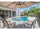 Backyard swimming pool featuring a fountain and a spacious patio with comfortable seating and an umbrella at 81 Cascade Dr., Murrells Inlet, SC 29576