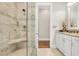 Tiled walk-in shower with glass enclosure, seating, and stone floor in a bright and spacious bathroom at 81 Cascade Dr., Murrells Inlet, SC 29576