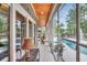 Sunroom with tongue and groove ceiling, brick walls, tile flooring, and backyard and pool views at 81 Cascade Dr., Murrells Inlet, SC 29576