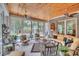 Sunroom with tongue and groove ceiling, brick walls, tile flooring, and backyard and pool views at 81 Cascade Dr., Murrells Inlet, SC 29576