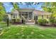 Expansive backyard with lush lawn, mature trees, and a screened-in porch at 840 Jeter Ln., Myrtle Beach, SC 29588