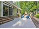 Outdoor fireplace and blue Adirondack chairs highlight this backyard's serene charm at 840 Jeter Ln., Myrtle Beach, SC 29588