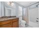 Traditional bathroom featuring a granite-topped vanity, toilet, and a shower-tub combination at 840 Jeter Ln., Myrtle Beach, SC 29588