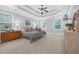 Spacious main bedroom with tray ceiling, multiple windows, and carpet floors at 840 Jeter Ln., Myrtle Beach, SC 29588