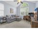 Comfortable office space with a gray sofa, desk, and large windows providing natural light at 840 Jeter Ln., Myrtle Beach, SC 29588