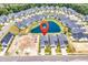 Community aerial view featuring a scenic pond, modern homes, and construction site with the location pointer included at 8469 Cape Dutch Loop, Myrtle Beach, SC 29572