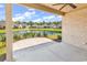 Serene covered back patio overlooking a scenic pond with a fountain and well-maintained landscaping, ideal for outdoor relaxation at 8469 Cape Dutch Loop, Myrtle Beach, SC 29572