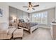 Relaxing bedroom with wainscoting, wood-look flooring, and a large window at 8469 Cape Dutch Loop, Myrtle Beach, SC 29572