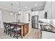 The open-concept kitchen has stainless steel appliances and a center island with barstool seating at 8469 Cape Dutch Loop, Myrtle Beach, SC 29572