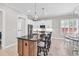 The kitchen features stainless steel appliances, a center island with seating, and a bright dining area at 8469 Cape Dutch Loop, Myrtle Beach, SC 29572