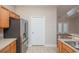Bright kitchen with stainless steel refrigerator and wood cabinets, conveniently located next to door at 908 Wrigley Dr. # 17-3_17-3G, Myrtle Beach, SC 29588