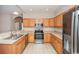 Updated kitchen with stainless steel appliances, wood cabinets, and tile flooring at 908 Wrigley Dr. # 17-3_17-3G, Myrtle Beach, SC 29588