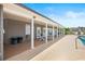 Community pool deck with white columns, lounge chairs, and shade at 908 Wrigley Dr. # 17-3_17-3G, Myrtle Beach, SC 29588