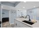 A view from the kitchen to the living room and bedroom, featuring modern cabinets and stainless steel appliances at 9550 Shore Dr. # 529, Myrtle Beach, SC 29572