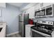 Close up of the kitchen featuring stainless steel appliances and white cabinets, perfect for preparing meals at 9550 Shore Dr. # 529, Myrtle Beach, SC 29572