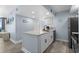 Stylish kitchen island with white cabinets, a sink, and plenty of counter space for meal preparation with stainless appliances at 9550 Shore Dr. # 529, Myrtle Beach, SC 29572
