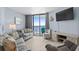 Cozy living room with a couch, accent chair, TV, and access to a balcony with ocean views at 9550 Shore Dr. # 529, Myrtle Beach, SC 29572
