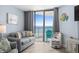 Bright living room with ocean view from the balcony, a comfortable sofa and a fun coastal décor at 9550 Shore Dr. # 529, Myrtle Beach, SC 29572