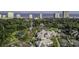 An aerial view of manicured grounds with tennis courts, a pool, and verdant trees at 9840 Queensway Blvd. # 227, Myrtle Beach, SC 29572