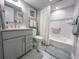 Bathroom with vanity, grey cabinet, marble floors, and a shower/tub combo at 9840 Queensway Blvd. # 227, Myrtle Beach, SC 29572