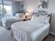 Bedroom with two beds, decorative pillows, and turtle themed wall art at 9840 Queensway Blvd. # 227, Myrtle Beach, SC 29572