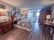Bedroom featuring a large bed, sliding glass door to a balcony, and tropical furnishings at 9840 Queensway Blvd. # 227, Myrtle Beach, SC 29572