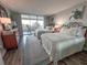Bedroom with two beds, a decorative dresser, and access to the outside balcony at 9840 Queensway Blvd. # 227, Myrtle Beach, SC 29572