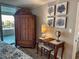 This bedroom features a wooden armoire, vanity, ocean themed wall art, and access to a balcony at 9840 Queensway Blvd. # 227, Myrtle Beach, SC 29572