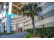 The building entrance features large support pillars, a palm tree, and a driveway at 9840 Queensway Blvd. # 227, Myrtle Beach, SC 29572