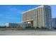 A modern high-rise condo building featuring multiple balconies and contemporary design at 9840 Queensway Blvd. # 227, Myrtle Beach, SC 29572