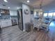 Well-designed kitchen open to the dining area with stainless steel appliances and white cabinetry at 9840 Queensway Blvd. # 227, Myrtle Beach, SC 29572