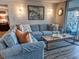 This comfortable living room has a large blue sectional sofa and modern decorations at 9840 Queensway Blvd. # 227, Myrtle Beach, SC 29572