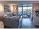 Cozy living room with a large sectional sofa and sliding glass doors to the oceanfront balcony at 9840 Queensway Blvd. # 227, Myrtle Beach, SC 29572