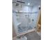 Glass shower featuring tiled walls, pebble tile flooring, and built-in shelves at 9840 Queensway Blvd. # 227, Myrtle Beach, SC 29572