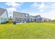 Expansive backyard with lush green grass, a patio with outdoor seating, and a screened-in porch at 1008 Mary Read Dr., North Myrtle Beach, SC 29582
