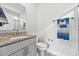 Bright bathroom with granite vanity top and gray cabinetry at 1008 Mary Read Dr., North Myrtle Beach, SC 29582