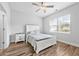 Cozy bedroom with a white bed frame, ceiling fan, and bright window at 1008 Mary Read Dr., North Myrtle Beach, SC 29582