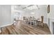Bright dining room featuring an elegant table set for six, coffered ceilings, and wood-look floors at 1008 Mary Read Dr., North Myrtle Beach, SC 29582