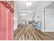 Bright foyer with wood-look flooring, an open view to the dining and living spaces, and a charming blue cabinet at 1008 Mary Read Dr., North Myrtle Beach, SC 29582