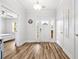 Welcoming foyer with a white front door, wood-look flooring, and a glimpse into a bedroom and living area at 1008 Mary Read Dr., North Myrtle Beach, SC 29582