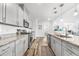 Modern kitchen featuring sleek gray cabinets, stainless steel appliances, granite countertops, and a tiled backsplash at 1008 Mary Read Dr., North Myrtle Beach, SC 29582