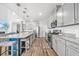 Open-concept kitchen with a central island, stainless steel appliances, ample cabinetry, and wood-look flooring at 1008 Mary Read Dr., North Myrtle Beach, SC 29582