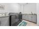 Well-lit laundry room features modern appliances and ample granite countertop space for folding and storage at 1008 Mary Read Dr., North Myrtle Beach, SC 29582