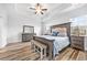 Elegant main bedroom with tray ceiling, bench, and wood-look flooring at 1008 Mary Read Dr., North Myrtle Beach, SC 29582