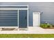 Exterior of home featuring outdoor shower, white door, blue siding and gas and electric hookups at 1008 Mary Read Dr., North Myrtle Beach, SC 29582