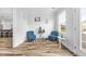 Cozy sitting area with blue-themed decor, natural light and wood-look floors at 1008 Mary Read Dr., North Myrtle Beach, SC 29582