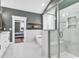 Modern bathroom featuring a glass shower, soaking tub, and marble tile flooring for a luxurious spa-like experience at 103 Pigeon Forge Ct., Murrells Inlet, SC 29576