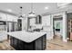 Well-equipped kitchen showcasing a large island, stainless steel appliances, and stylish pendant lighting at 103 Pigeon Forge Ct., Murrells Inlet, SC 29576