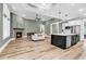 Open-concept living room and kitchen area with a fireplace, creating a warm and inviting space at 103 Pigeon Forge Ct., Murrells Inlet, SC 29576