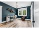 Home office with stylish desk, shelving, and natural light provides a functional and inviting workspace at 103 Pigeon Forge Ct., Murrells Inlet, SC 29576